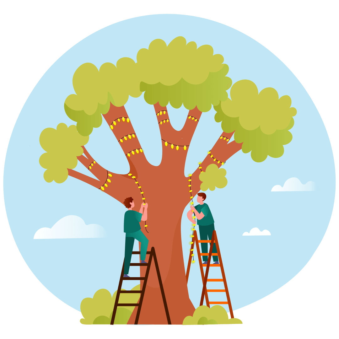 Two people on ladders are stringing yellow lights around a large tree under a blue sky with clouds.